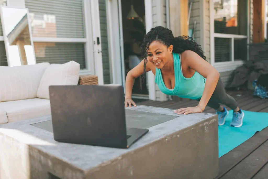Mulher fazendo flexões com apoio em casa.